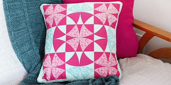 Machine embroidery quilted pillow sitting on a chair 