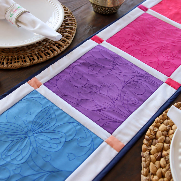 Machine embroidery floral quilting designs on a colorful table runner